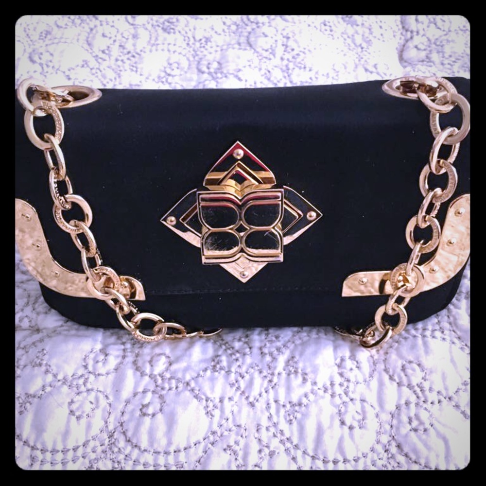 BCBG black clutch with gold hardware details.